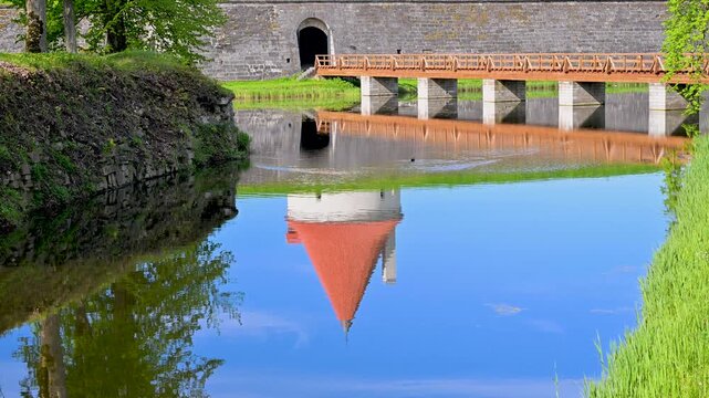 Kuressaare Castle tower reflection in the calm moat water