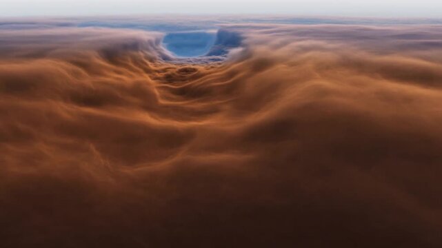 Orange clouds form layered waves beneath a bright horizon and blue sky