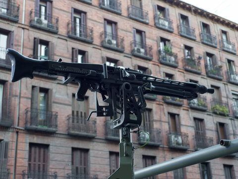 Mounted machine gun on a vehicle in front of apartment buildings