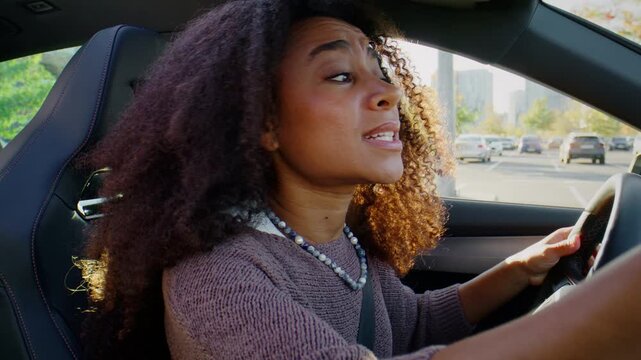 Frustrated woman complains about traffic while driving car