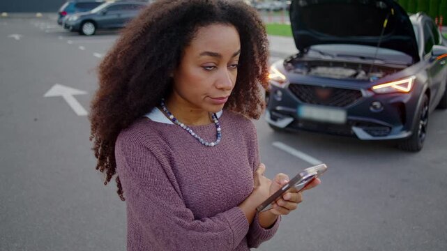 Woman holds phone in hand and writes message to service center