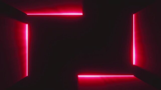 Four bright red laser beams converging from corners towards center on a deep black background video footage