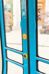 Blue bus door with wheelchair access button and close up of glass © Sabineyro