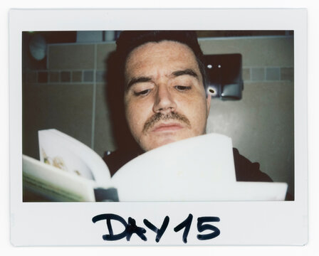 Man Reading a Book on Day 15 With sitting on WC