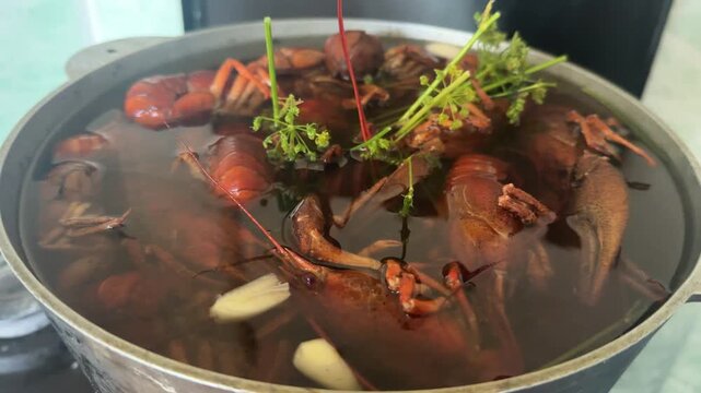 Cooking fresh river Fresh river crayfish boiling in a metal pot with dill, garlic and spices.crawfish with dill and garlic in pot . High quality 4k footage