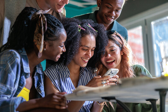Group of friends looking at a smartphone together
