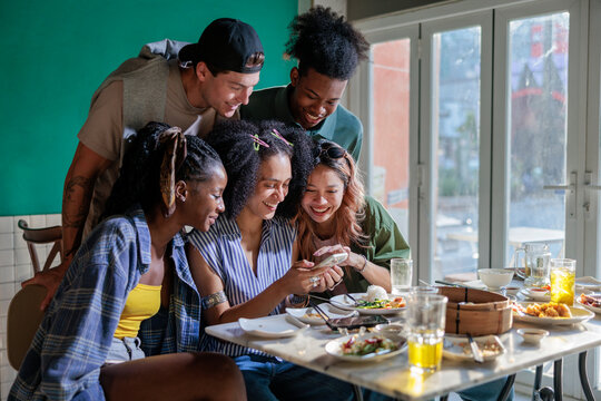 Group of friends examining a smartphone together