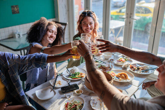 Group of friends make a toast at a restaurant