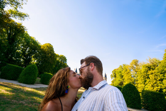 Couple Sharing a Kiss in a Park