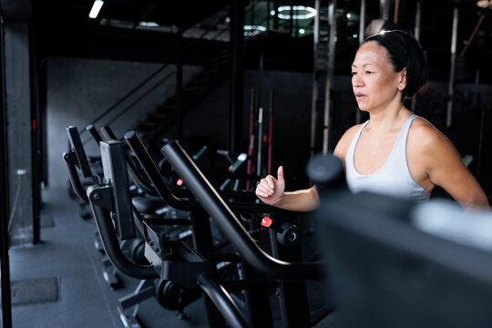 Woman exercises on a stationary bike at the gym