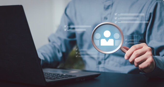 Employee screening and hiring. Business recruitment, professional using a magnifying glass to review candidate profiles on a laptop, with digital checklists.