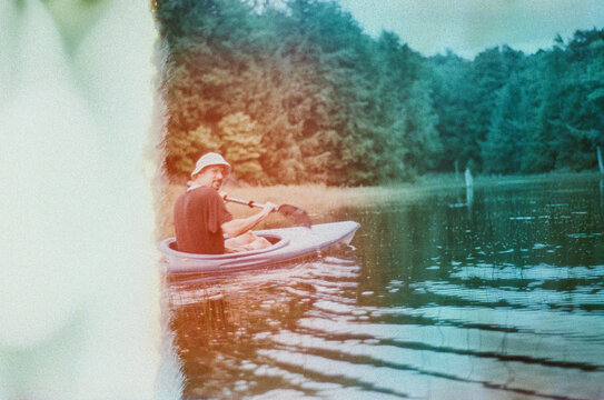 Man kayaking on a lake in Quebec, Mont Tremblant area.