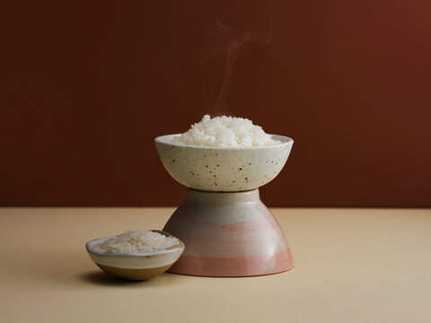 Steaming hot white rice served in artisanal ceramic bowls