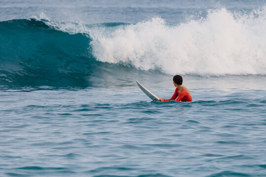 Surfer woman on surfboard in sea. Surfer woman in water
