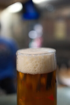 Cold Beer Served in a Glass Mug with Golden Color and Foam