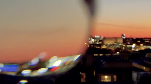Close View Through Round Glasses at an Orange Sunset Skyline