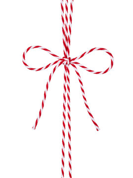 Red and white bakers twine bow isolated on black background