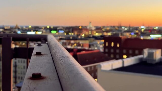 Helsinki Cathedral and City Lights at Dusk Behind a Rooftop Railing