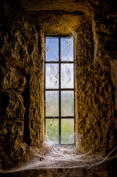 Narrow Leaded Window with Cobwebs in Rough Stone Wall, St Silas Church, Blackburn, Lancashire
