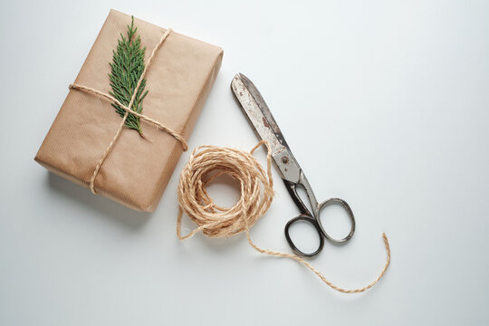 Wrapping a Gift With Twine and a Sprig of Greenery