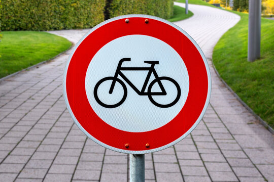 Municipal european road sign restricting bicycle traffic in public pedestrian zone with paved footpath. Regulatory street sign for urban mobility and municipal traffic rules concepts