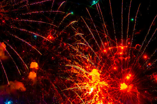 Fireworks close-up. Multicolored fireworks in the night sky, bright festive background with space for text.