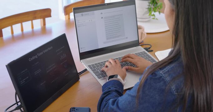 African American woman typing on laptop, tapping coding tutor monitor prompt, picking up phone