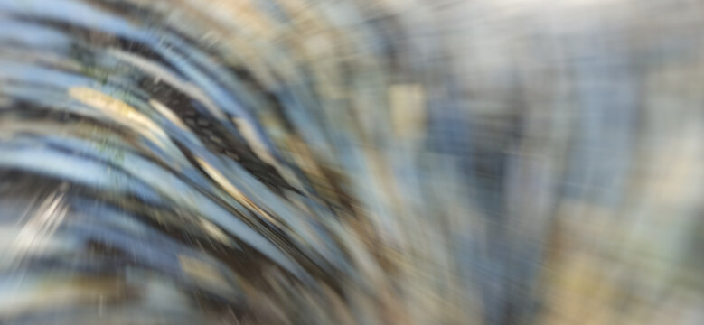 Abstract kinetic motion blur background featuring curved speed streaks in steel blue and neutral tones. Modern dynamic light flow texture for corporate tech designs and digital web banners.