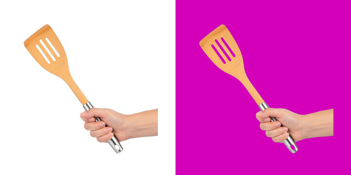 A hand holding a bamboo kitchen spatula with a silver handle for cooking food transparent png