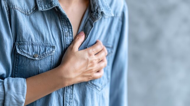 hand hold chest with heart attack symptoms, have chest pain caused by heart disease, leak, dilatation, enlarged coronary heart, press on the chest with a painful expression
