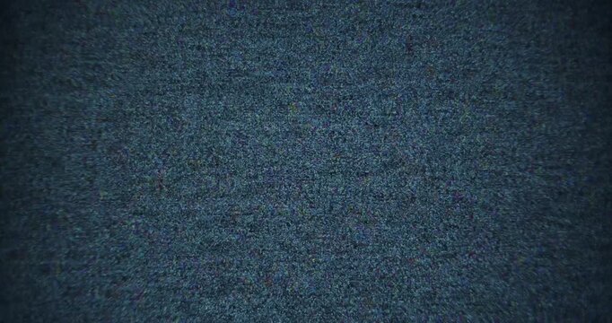 Abstract footage of white noise, static interference, and digital-looking glitches filmed frontal from a screen using vintage optics. Flickering visual distortion creates a retro electronic aesthetic.