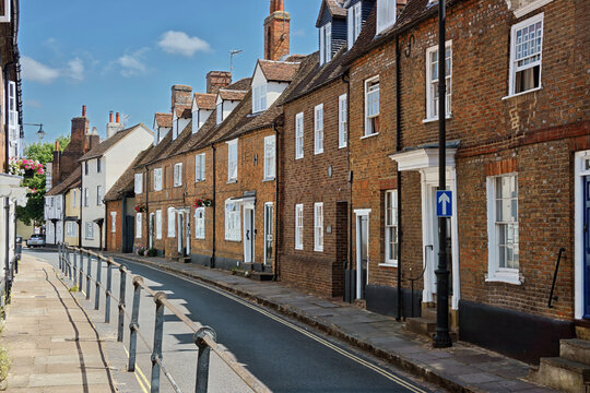 Historic town street view featuring traditional 17th and 18th-century red brick period buildings, timber-framed architecture, and pitched tile roofs along Castle Street in Aylesbury.