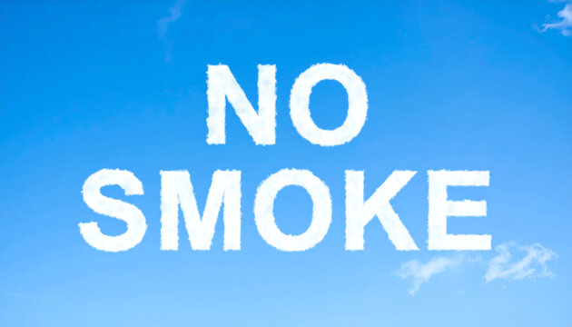 No smoke sign written as white fluffy clouds against a bright clear blue sky during a sunny summer day time