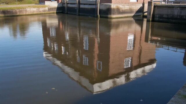 Building reflection at feildes weir lock on a calm day