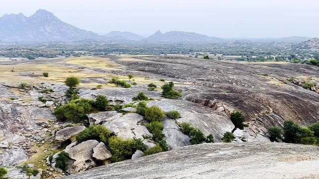 An aerial view of a rugged rocky landscape with granite hills in The Jawai Rajasthan