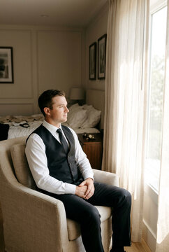 Groom Preparing for Wedding in Modern Bedroom, Elegant Grooming Ritual and Masculine Sophistication Concept