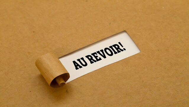 Au Revoir text message revealed through torn brown paper, farewell announcement on white background, minimalist commercial graphic