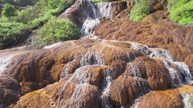 Water cascading over golden mineral terraces of the Golden Waterfall, Jinguashi, New Taipei, Taiwan
