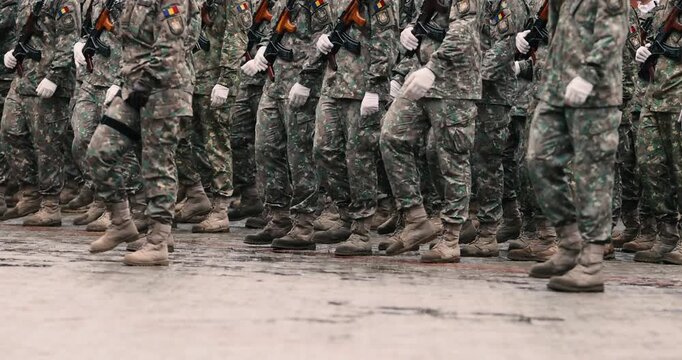 Romanian army soldiers prepare to march during a military ceremony.