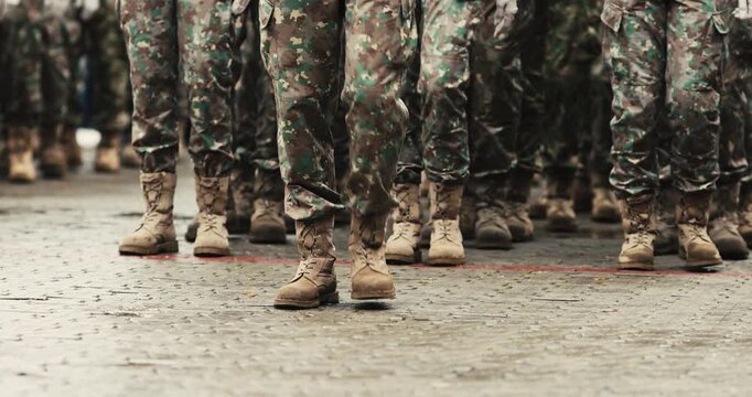 Romanian army soldiers prepare to march during a military ceremony.
