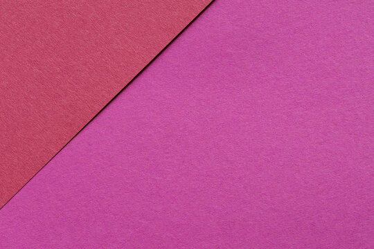 Magenta and red paper texture background with a diagonal shadow along the edge of overlapping sheets