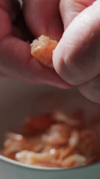 Hand Peeling Fresh Cooked Shrimp Close-Up Detail Vertical Video