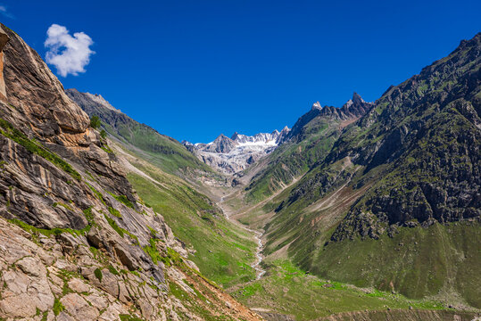 Panoramic view of glacial u-shaped valley having snow cladded peaks, glaciers and moraines  deposited by glacier in high altitude Himalayas mountain region of Himachal Pradesh, India.