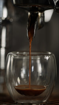 pour espresso in double wall glass closeup