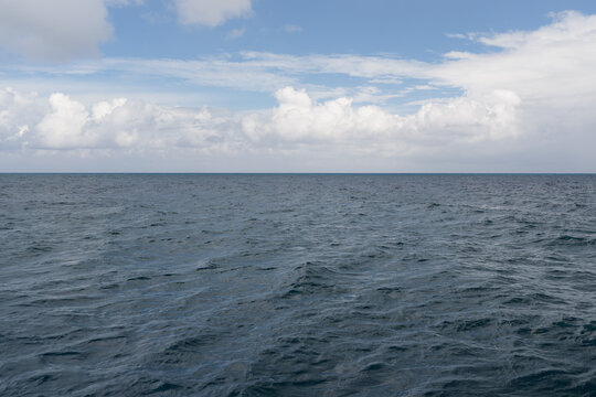 Ocean waves with turquoise water and white clouds