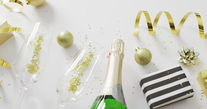 Decorations and champagne on white background at new year's eve