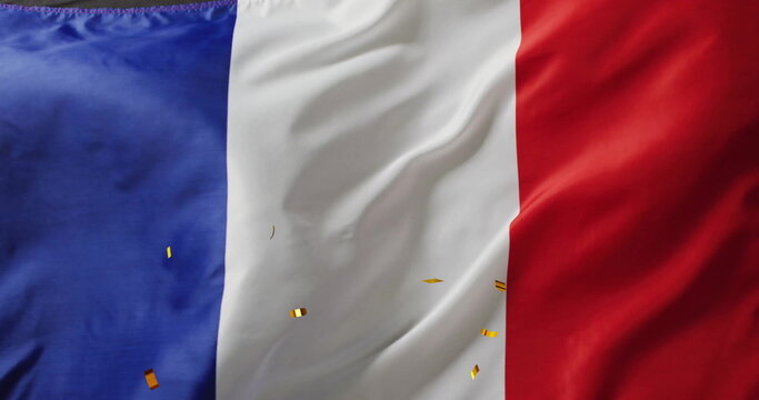 Image of confetti falling over flag of france