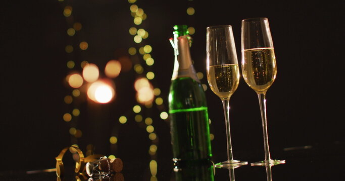 Champagne glasses and decorations on black background at new year's eve