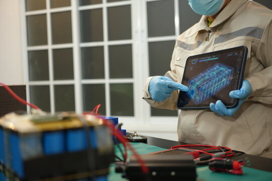 The skilled technician works on the lithium phosphate battery circuit board with his partner.