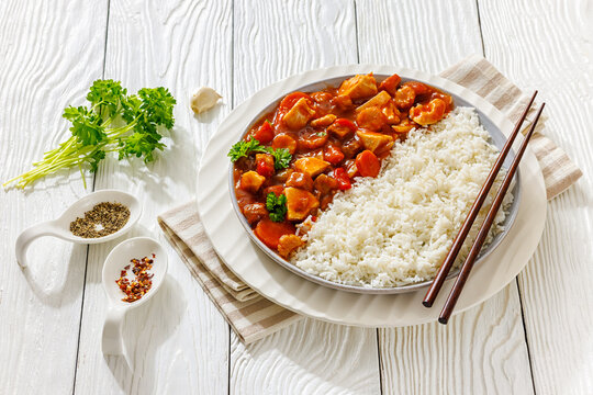 chicken cubes and veggies in red sauce with rice